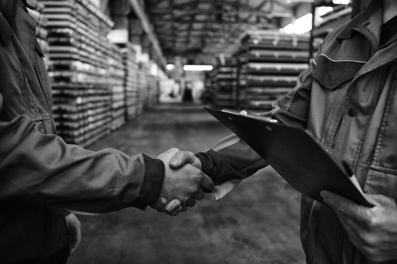 Hand shake in logistics warehouse